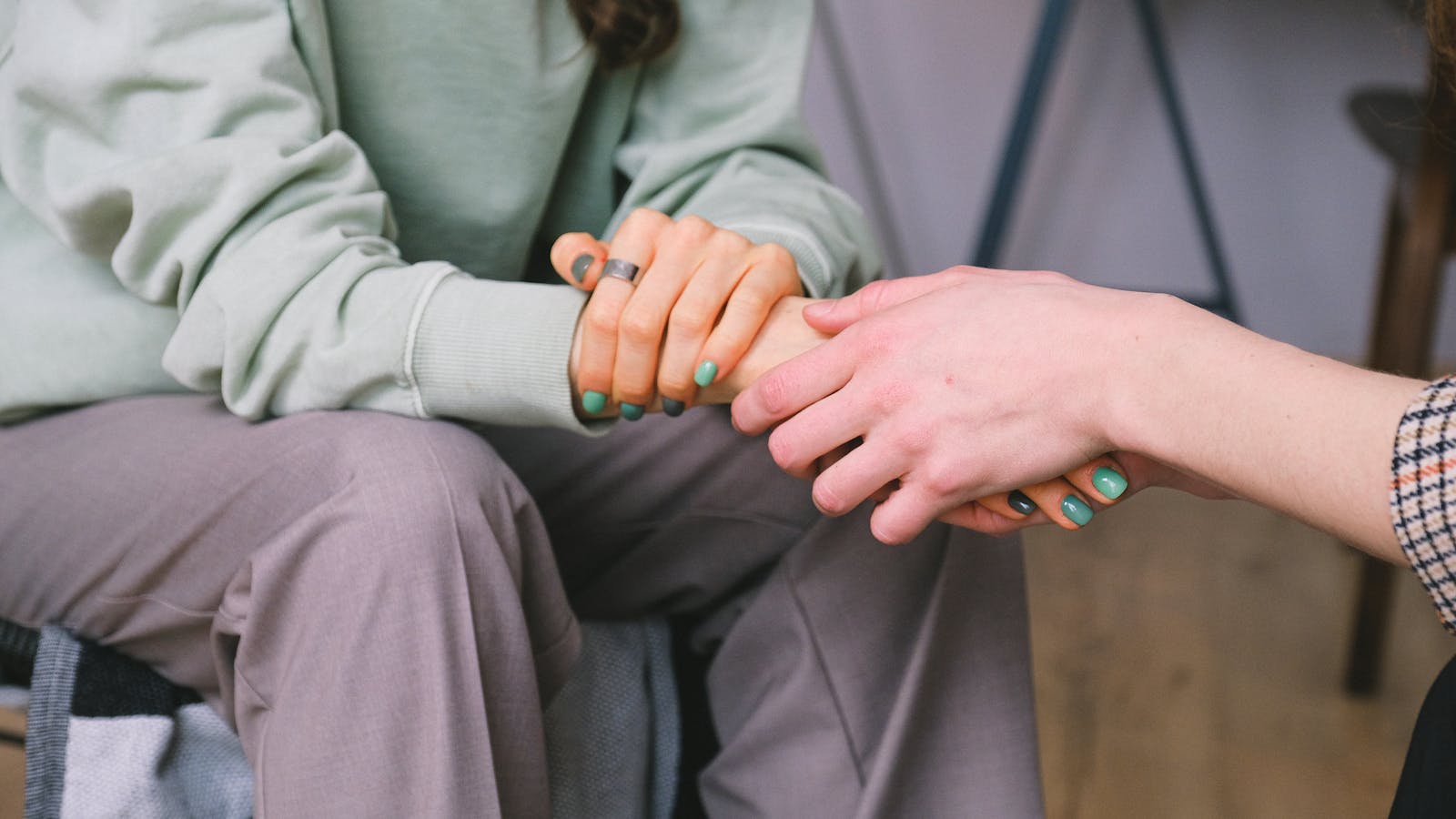 Two hands holding in emotional support