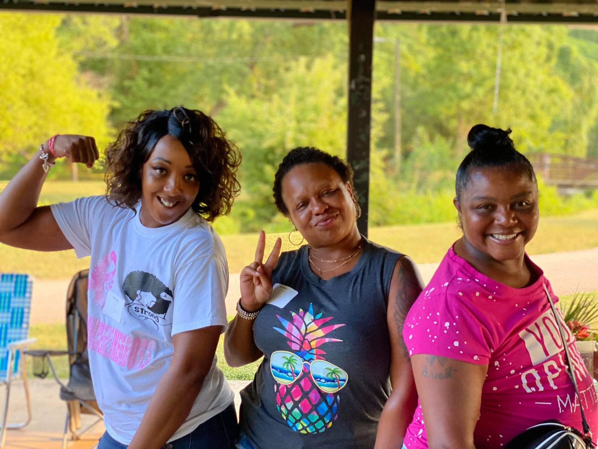 Three Breast Connect members posing together at an outdoor community event