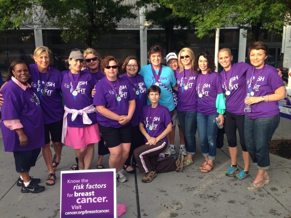 Breast Connect community members in purple Finish the Fight t-shirts gathered at a breast cancer awareness walk